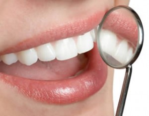 White teeth and dental mirror